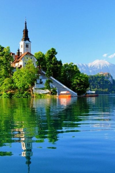 St martin church on island and bled lake landscape with mountain min Flurl 3 exciting vacation spots to visit